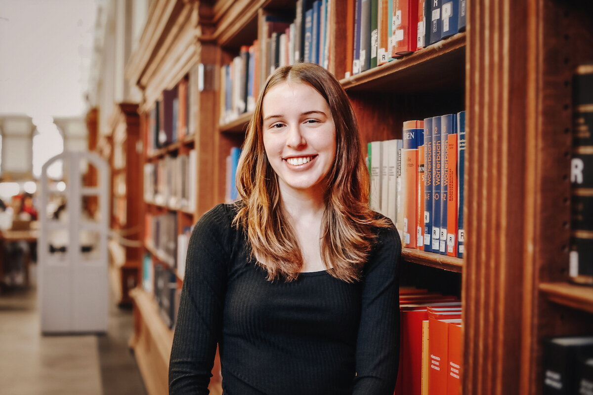 Student standing in the Main Library. 